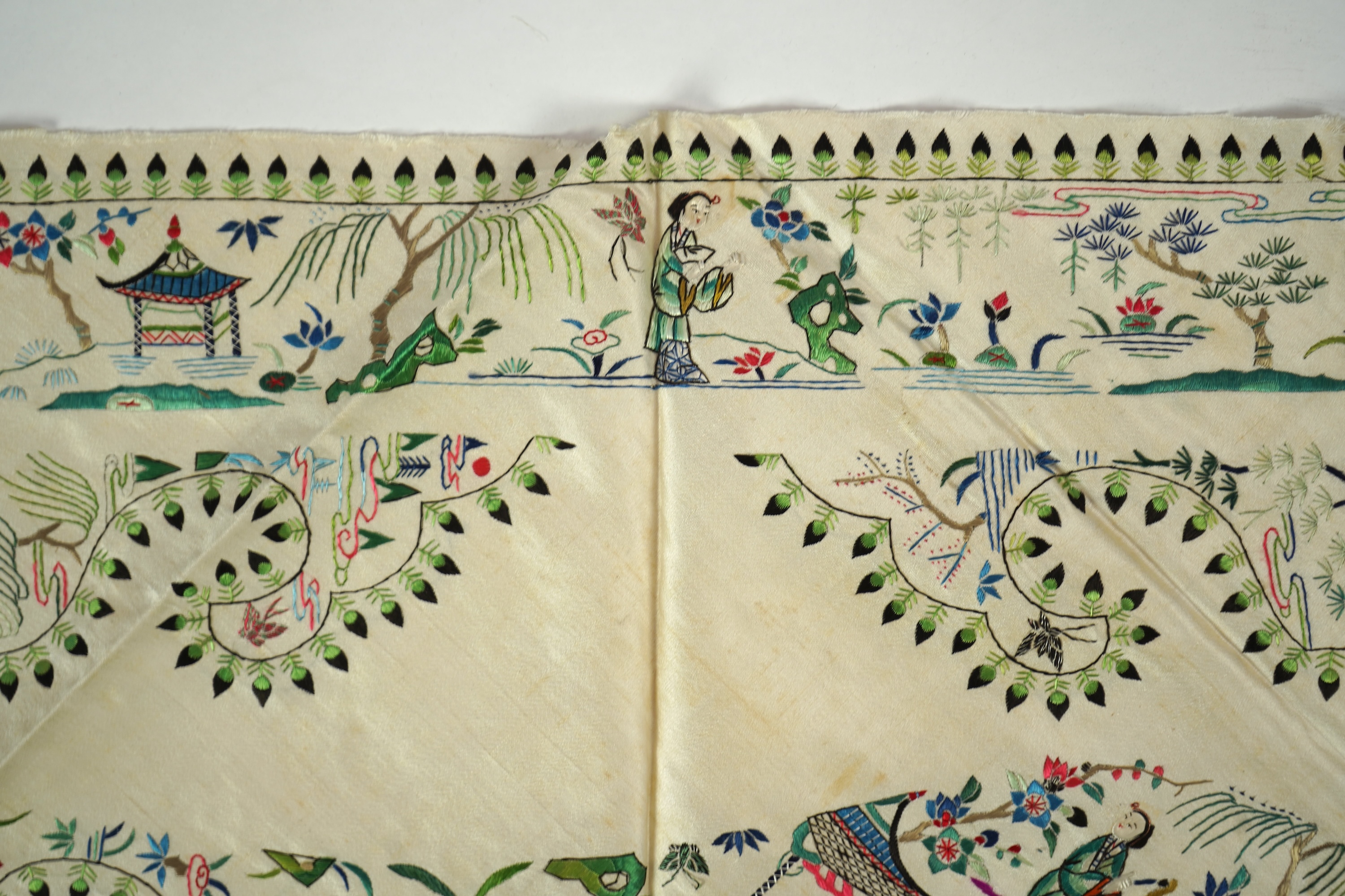 A Chinese embroidered silk panel of uncut robe borders, eleven similar sleeve panels and two other items, late Qing dynasty